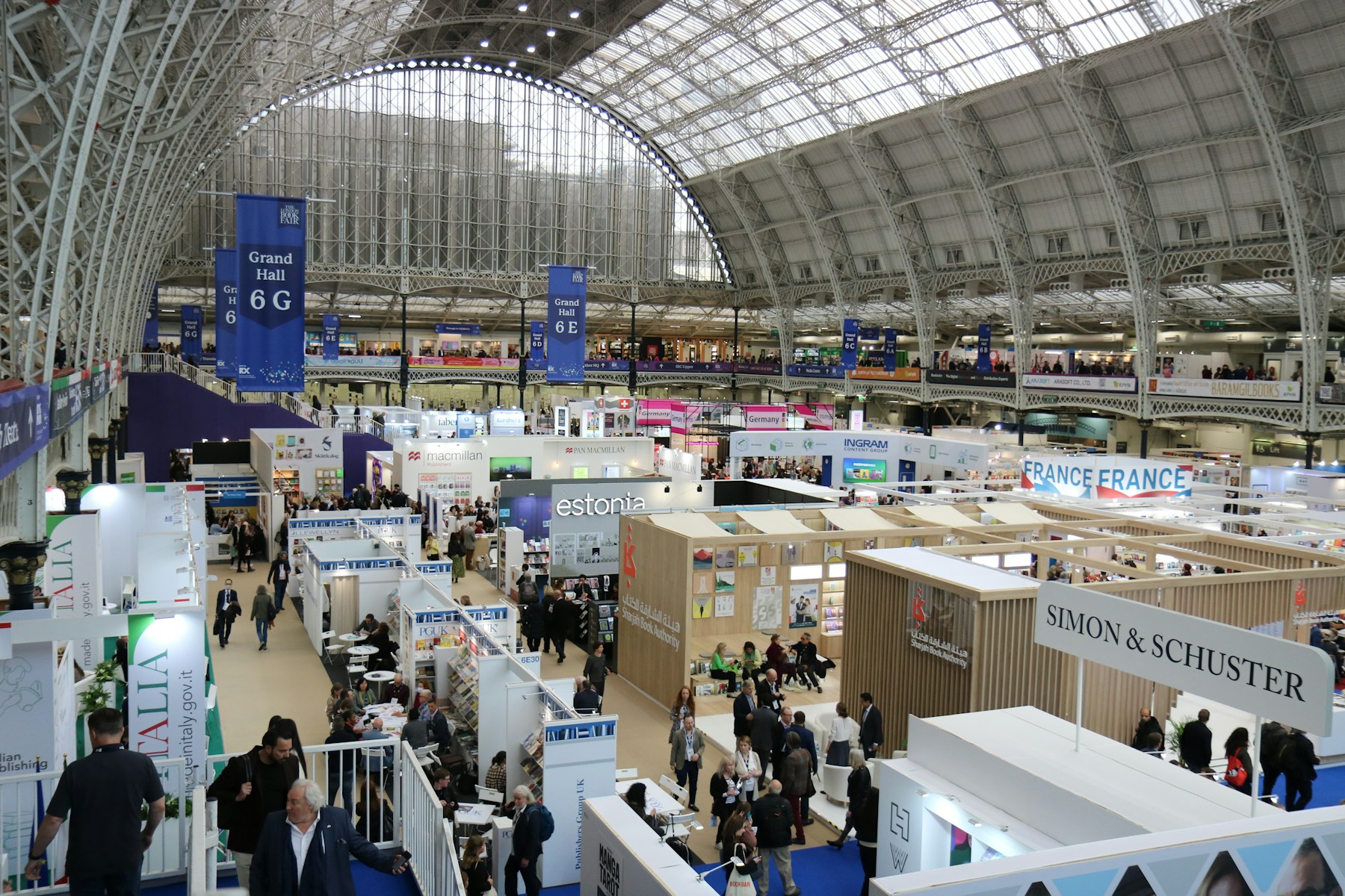 Exhibition stands and visitors in a large hall
