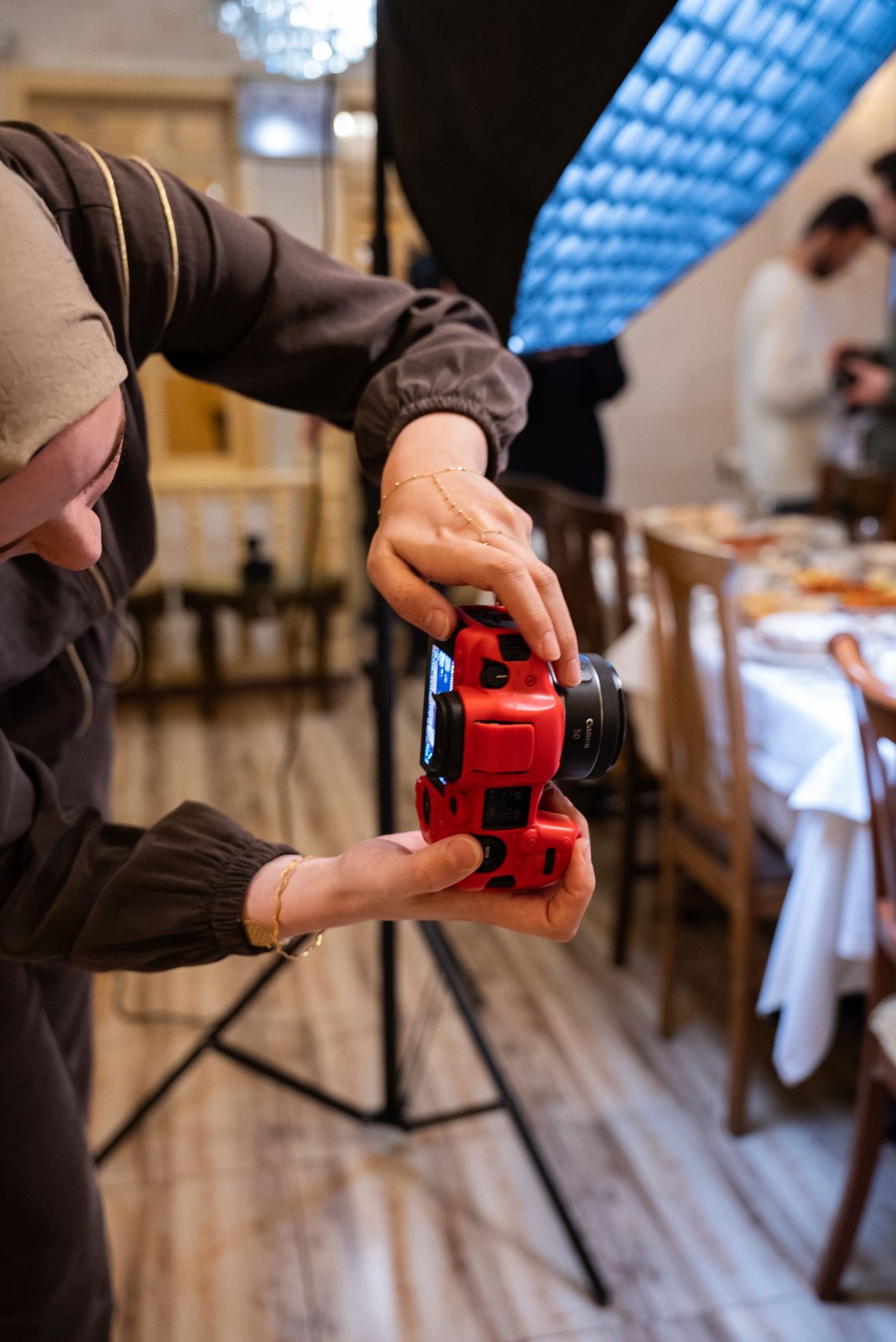 Person adjusting a camera during an event
