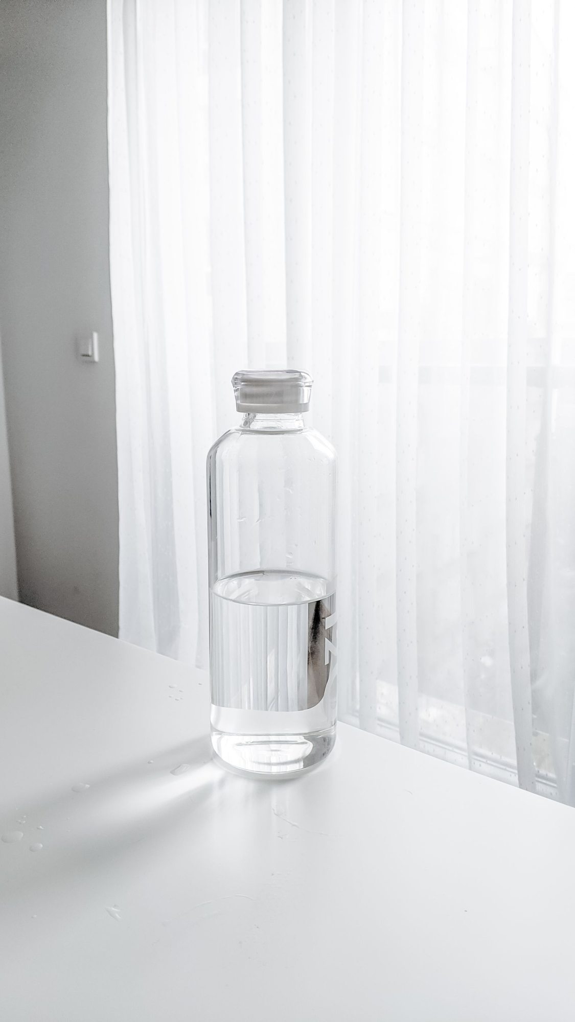 Water bottle on a light desk surface
