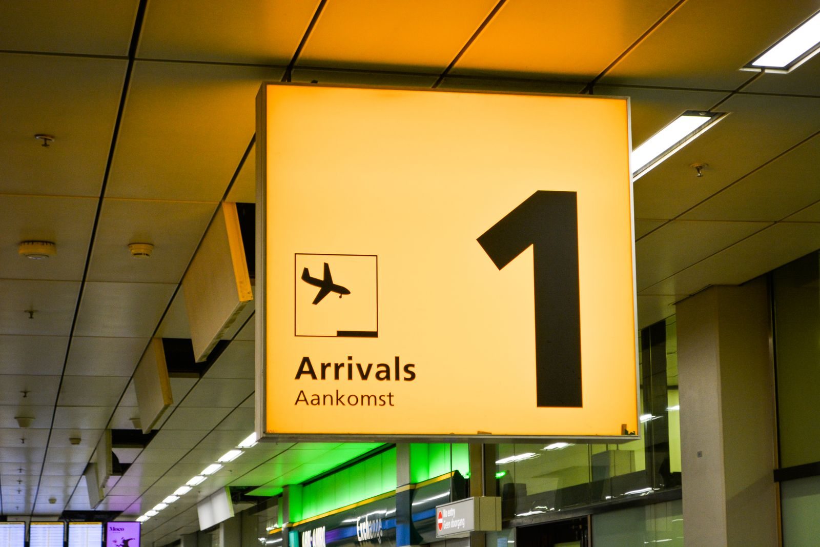 Yellow sign for an airport arrivals area
