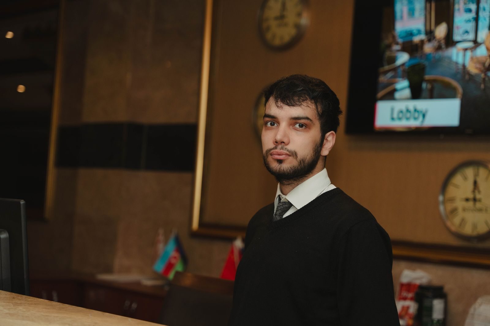 Staff member behind a hotel reception desk