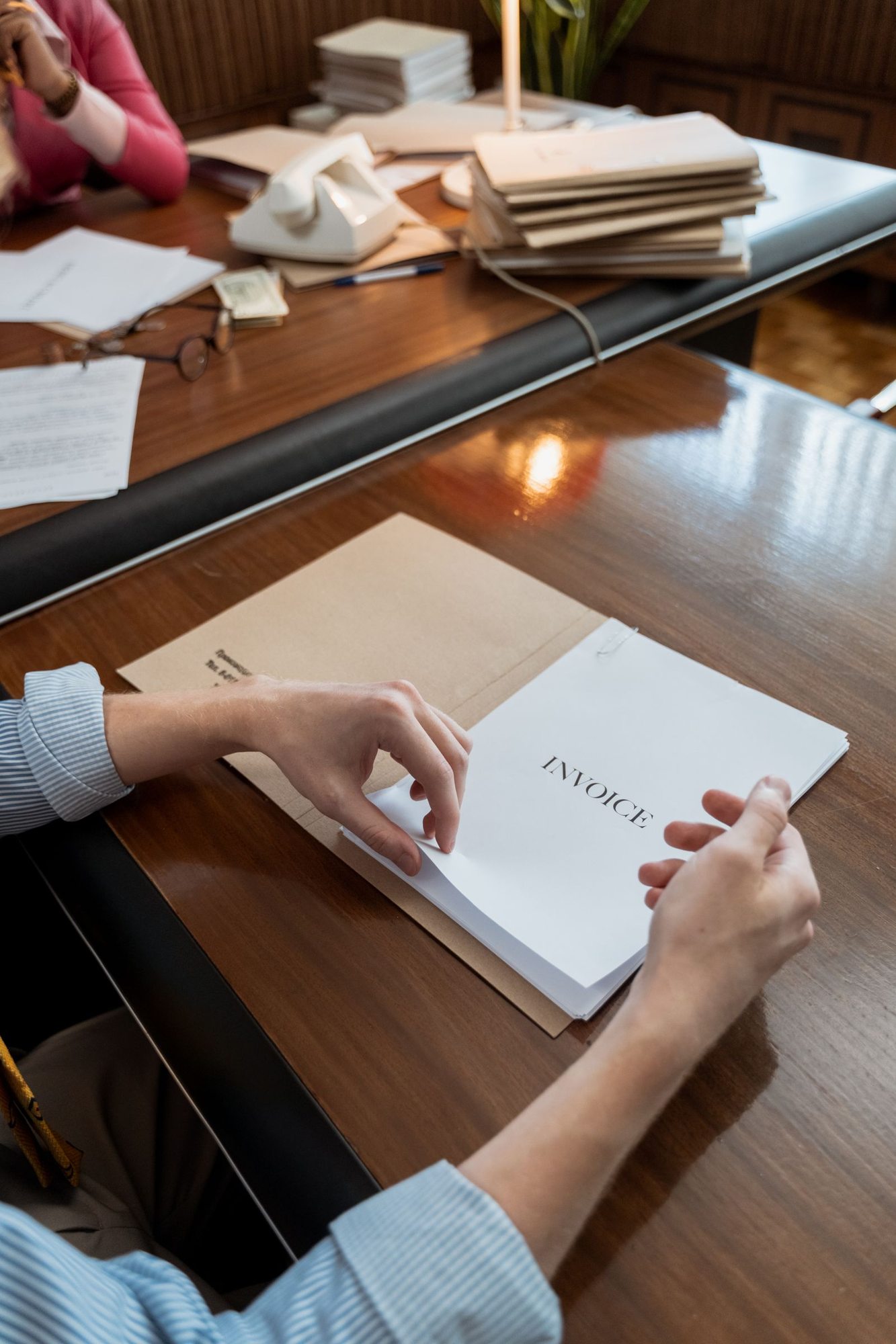 Person sorting invoices at a desk