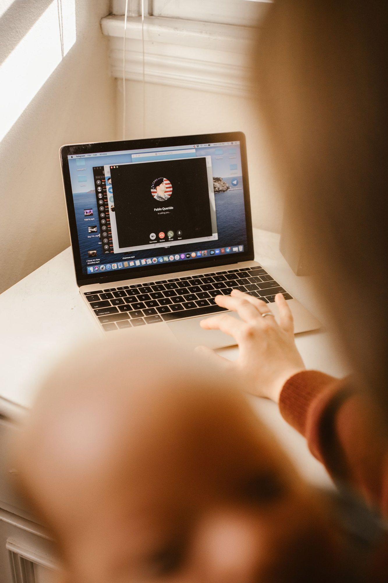 Person joining a video call on a laptop