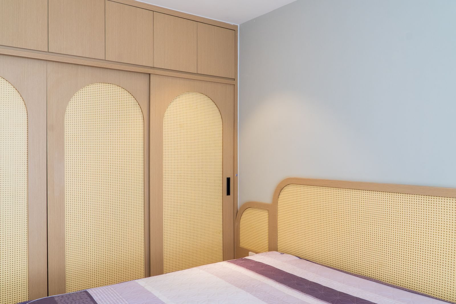 Wardrobe beside a bed