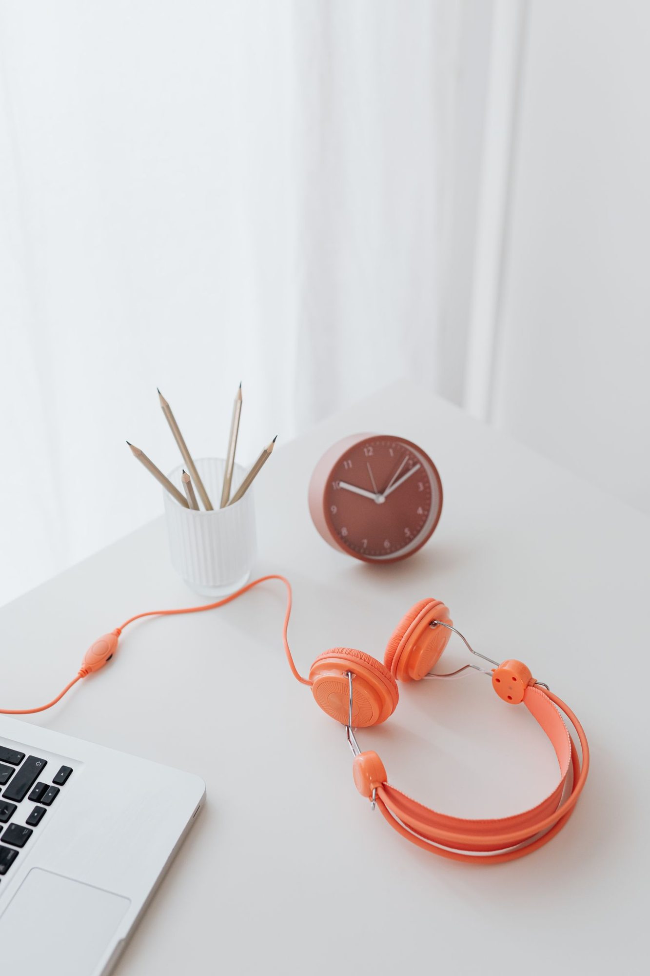 Headphones and a laptop on a tidy desk