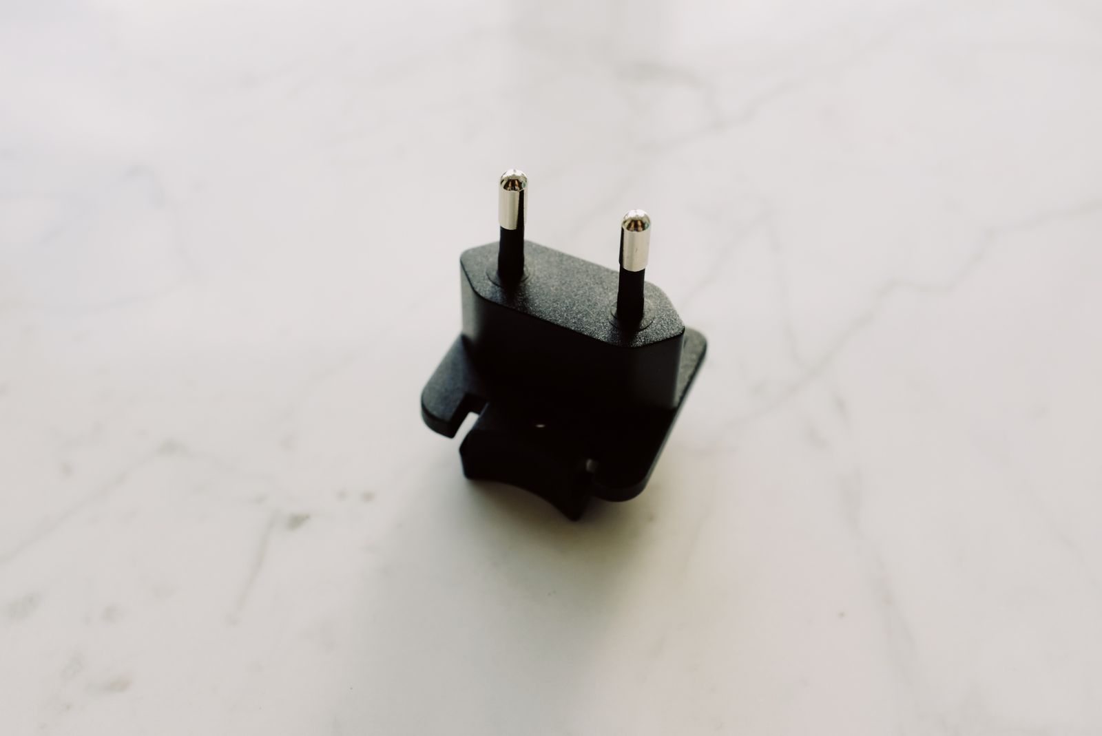 Electrical travel adapter on a light surface