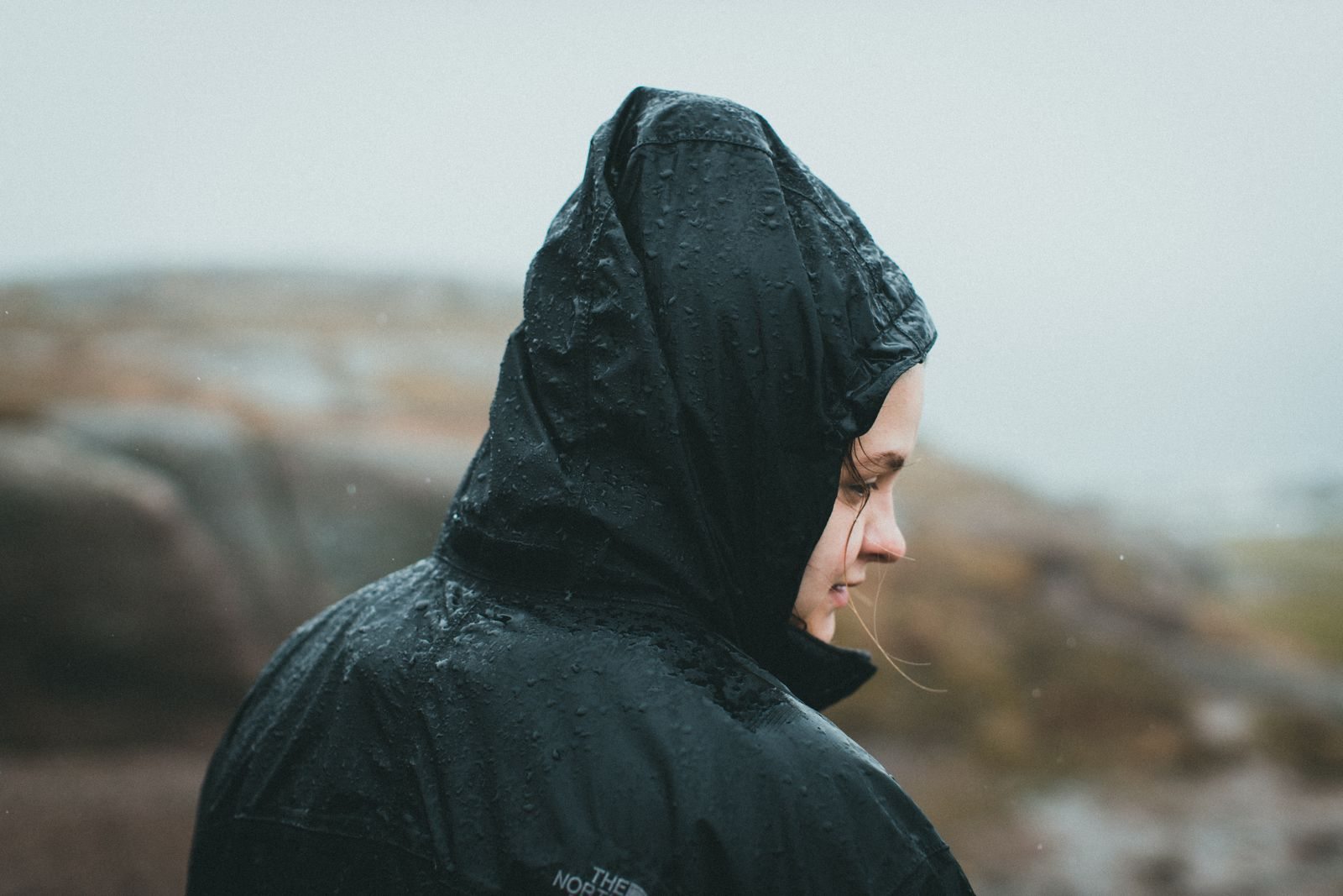 Person wearing a waterproof jacket in the rain