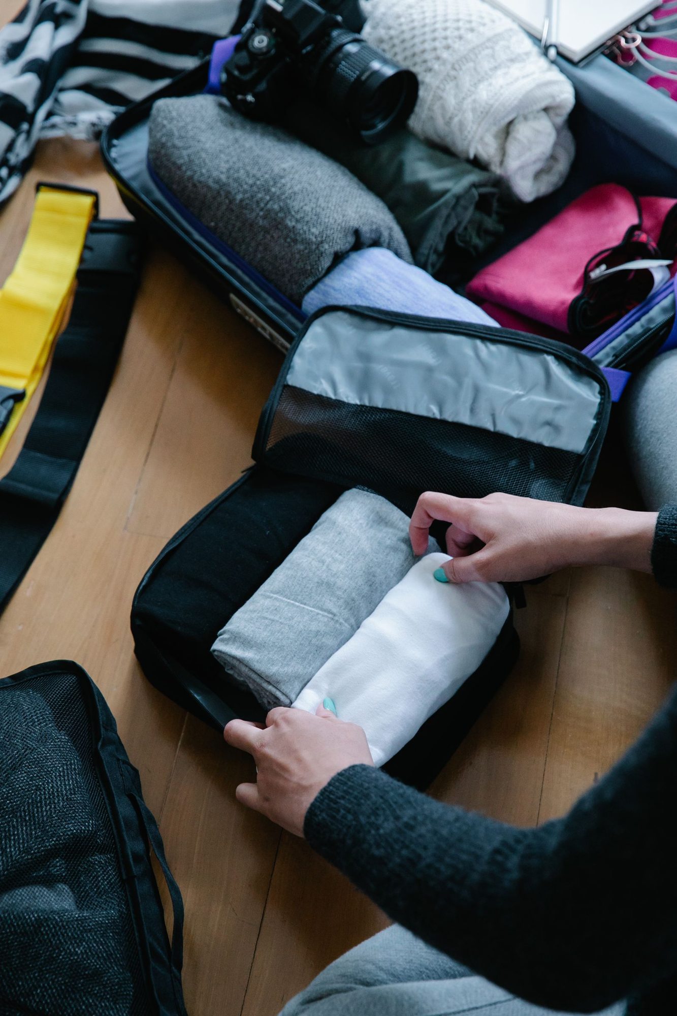 Folded clothing being placed into a packing cube
