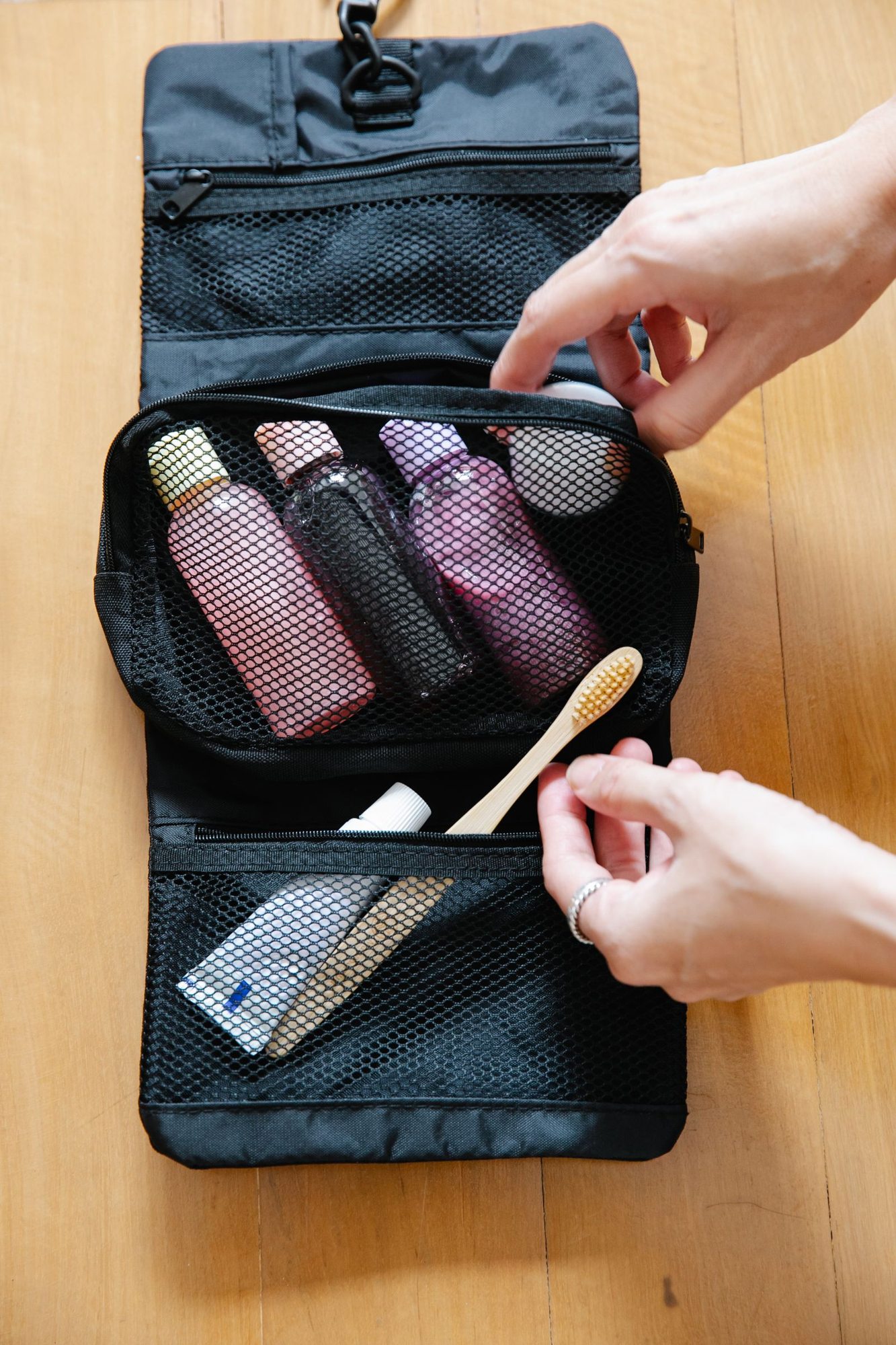 Open toiletries bag with small bottles