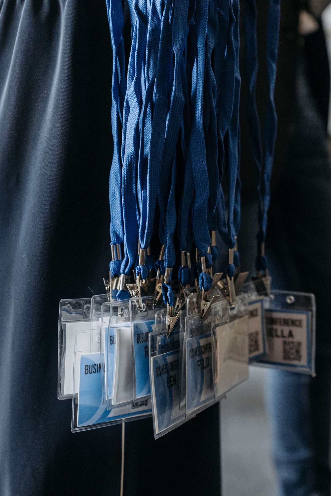 Event badges on blue lanyards